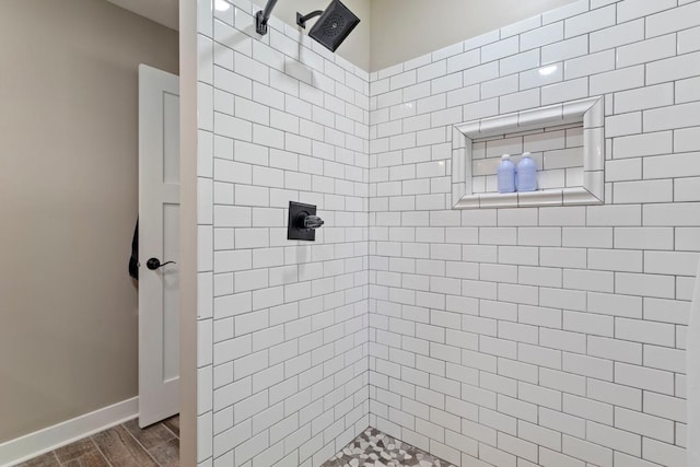 905 Sellards Dr, Dassel, MN 55325 - bathroom featuring a tile shower and wood finished floors