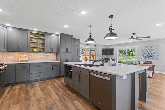 905 Sellards Dr, Dassel, MN 55325 - kitchen with appliances with stainless steel finishes, gray cabinets, open floor plan, light countertops, and wood finished floors