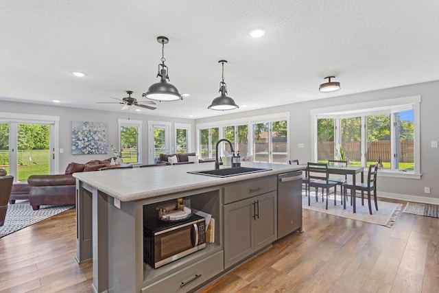 905 Sellards Dr, Dassel, MN 55325 - kitchen featuring stainless steel appliances, gray cabinets, light countertops, open floor plan, and recessed lighting