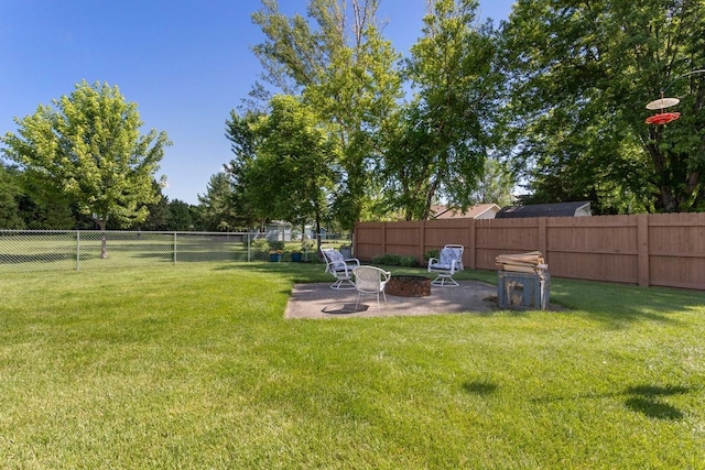 905 Sellards Dr, Dassel, MN 55325 - fenced backyard with an outdoor fire pit and a patio