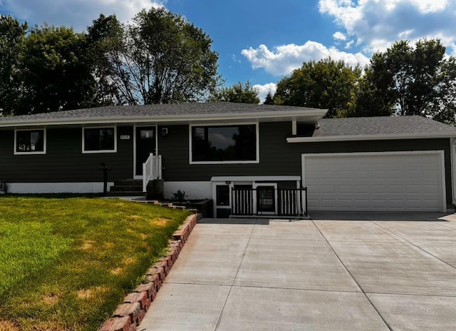6113 Scott Ave N, Brooklyn Center, MN 55429 - view of front of property featuring a garage, concrete driveway, a front lawn, and roof with shingles