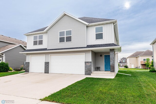 3137 6th St E, West Fargo, ND 58078 - view of front of house with an attached garage, board and batten siding, driveway, a front lawn, and brick siding