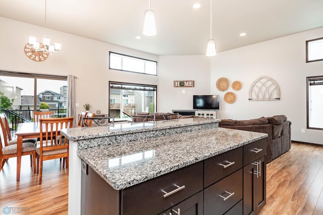 3137 6th St E, West Fargo, ND 58078 - kitchen with light wood-style floors, healthy amount of natural light, hanging light fixtures, recessed lighting, and a towering ceiling
