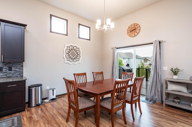 3137 6th St E, West Fargo, ND 58078 - dining area featuring a chandelier, light wood-type flooring, and a high ceiling