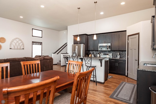 3137 6th St E, West Fargo, ND 58078 - dining space featuring light wood-type flooring, recessed lighting, and stairway