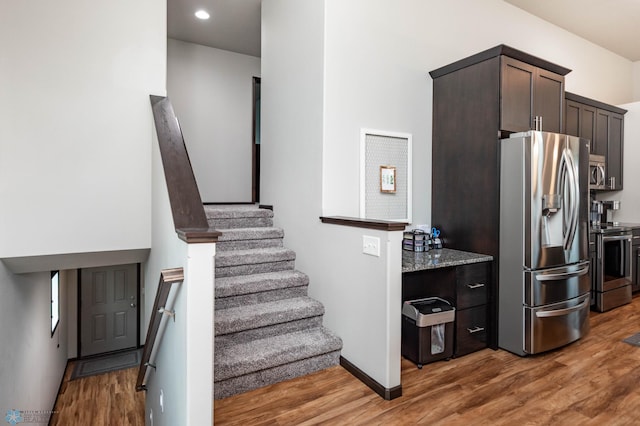 3137 6th St E, West Fargo, ND 58078 - staircase featuring wood finished floors and recessed lighting