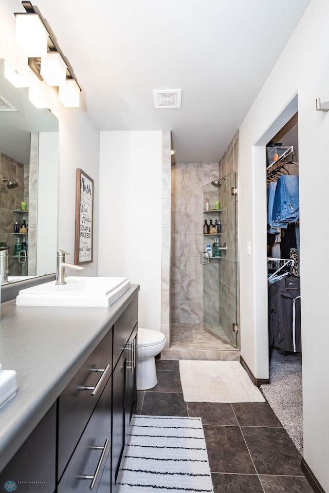 3137 6th St E, West Fargo, ND 58078 - bathroom featuring vanity, a tile shower, and a walk in closet