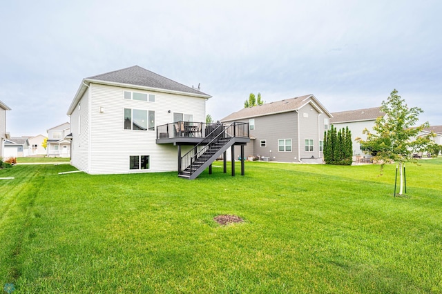 3137 6th St E, West Fargo, ND 58078 - back of house with stairs, a wooden deck, and a lawn