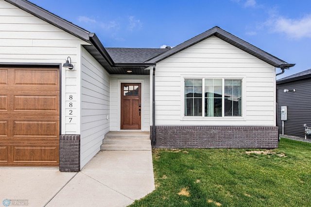 8827 Northern Lights Ave, Horace, ND 58047 - view of exterior entry with a lawn, brick siding, and a shingled roof
