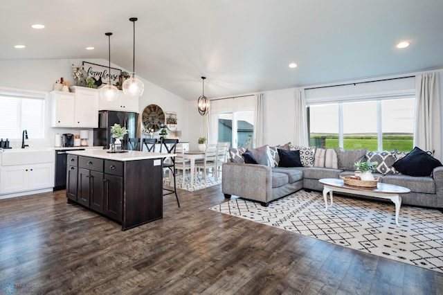 8827 Northern Lights Ave, Horace, ND 58047 - living room featuring lofted ceiling, dark wood-style flooring, recessed lighting, and a chandelier
