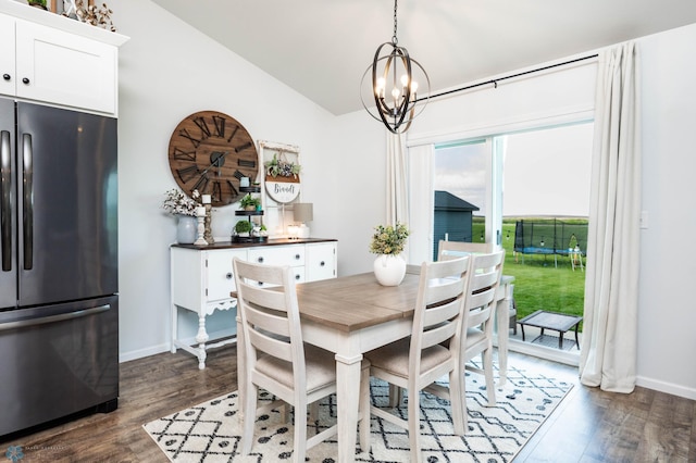 8827 Northern Lights Ave, Horace, ND 58047 - dining room with lofted ceiling, dark wood-style flooring, and a chandelier