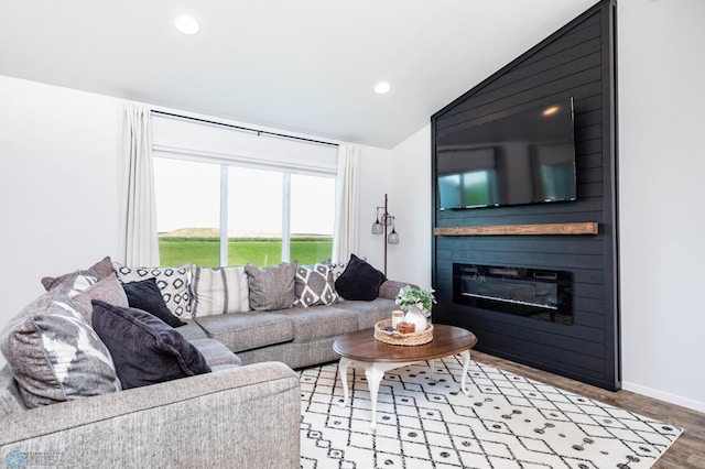 8827 Northern Lights Ave, Horace, ND 58047 - living area featuring vaulted ceiling, wood finished floors, recessed lighting, and a fireplace