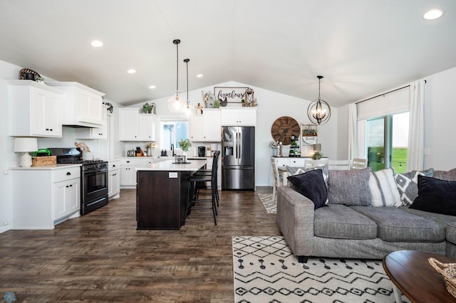 8827 Northern Lights Ave, Horace, ND 58047 - living area with vaulted ceiling, dark wood finished floors, recessed lighting, and a chandelier