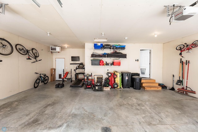 8827 Northern Lights Ave, Horace, ND 58047 - garage with a wall mounted AC and a garage door opener