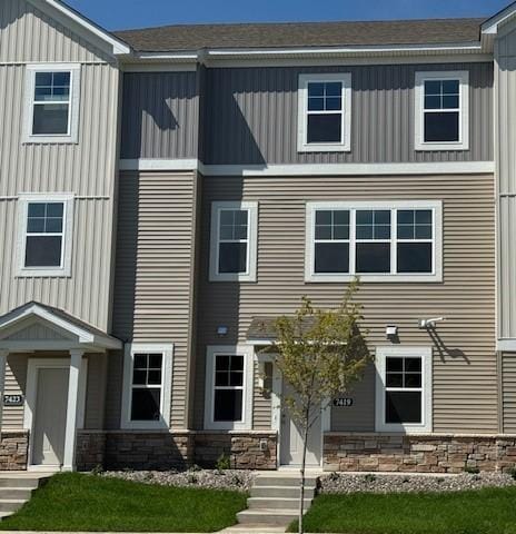 7419 E Ramsey Pkwy NW, Ramsey, MN 55303 - view of front of home featuring stone siding and a shingled roof