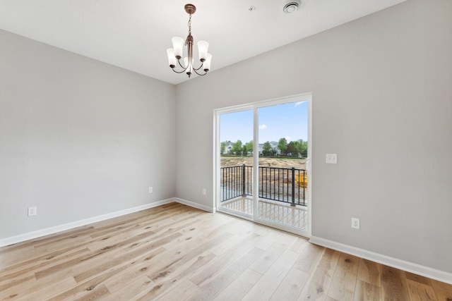 7419 E Ramsey Pkwy NW, Ramsey, MN 55303 - spare room featuring a chandelier and light wood-style floors