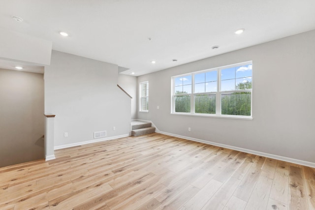 7419 E Ramsey Pkwy NW, Ramsey, MN 55303 - spare room featuring stairs, light wood-style floors, and recessed lighting