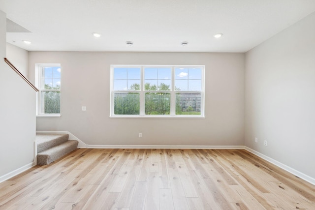7419 E Ramsey Pkwy NW, Ramsey, MN 55303 - spare room with stairs, light wood-style floors, and recessed lighting