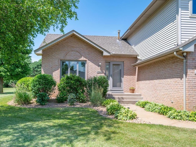 13680 57th St NE, Saint Michael, MN 55376 - view of front of house with brick siding, a front lawn, and roof with shingles