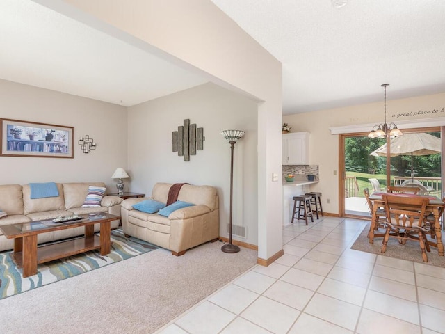 13680 57th St NE, Saint Michael, MN 55376 - living room featuring light tile patterned floors, light carpet, and a chandelier