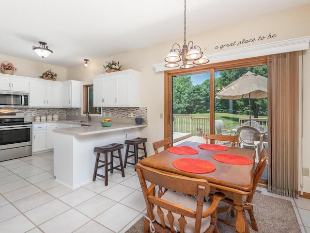 13680 57th St NE, Saint Michael, MN 55376 - dining space with a chandelier and light tile patterned floors
