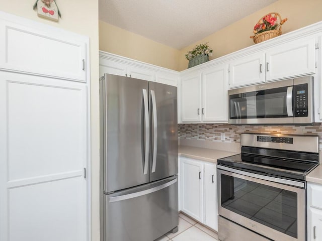 13680 57th St NE, Saint Michael, MN 55376 - kitchen with appliances with stainless steel finishes, white cabinets, light countertops, and a textured ceiling