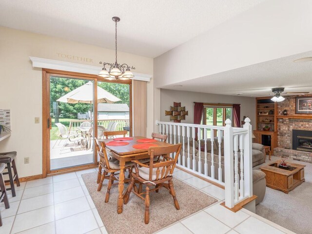 13680 57th St NE, Saint Michael, MN 55376 - dining area with light tile patterned flooring, a chandelier, built in features, and a brick fireplace