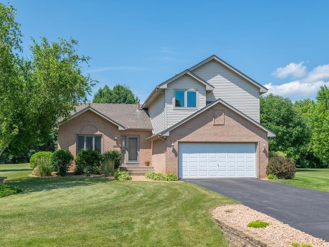 13680 57th St NE, Saint Michael, MN 55376 - view of front of property with driveway, brick siding, a front yard, and an attached garage