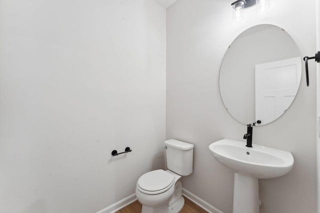 7415 E Ramsey Pkwy NW, Ramsey, MN 55303 - half bathroom with toilet and wood finished floors