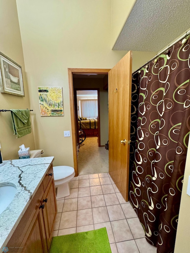 1815 49th St S, Fargo, ND 58103 - full bathroom with vanity, tile patterned floors, curtained shower, and a textured ceiling