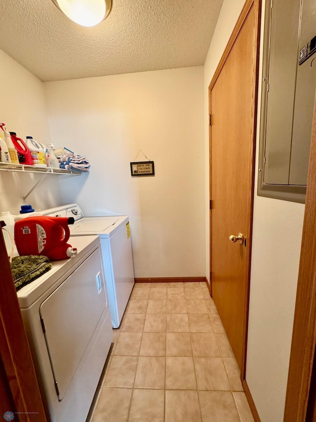 1815 49th St S, Fargo, ND 58103 - laundry room featuring a textured ceiling, separate washer and dryer, and light tile patterned floors