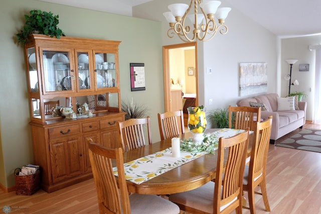 1815 49th St S, Fargo, ND 58103 - dining area featuring light wood-style floors, a chandelier, and lofted ceiling