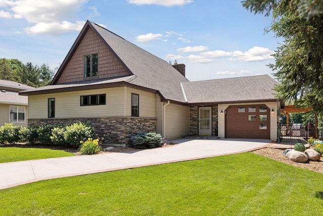 708 Riverside Dr N, North Hudson, WI 54016 - craftsman-style home featuring a garage, concrete driveway, stone siding, and a front lawn