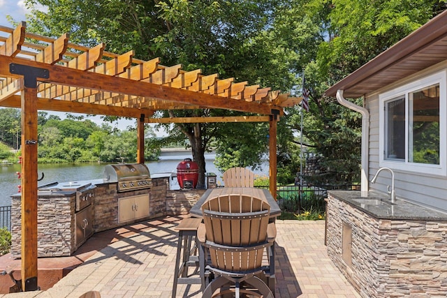 708 Riverside Dr N, North Hudson, WI 54016 - view of patio / terrace with exterior kitchen, an outdoor fire pit, a water view, and a pergola