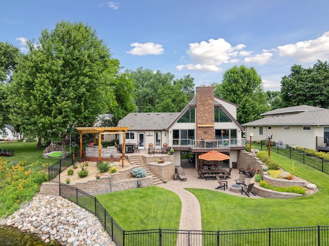 708 Riverside Dr N, North Hudson, WI 54016 - rear view of house with a pergola, a patio area, a deck, a fenced backyard, and a chimney