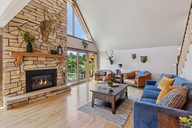 708 Riverside Dr N, North Hudson, WI 54016 - living area featuring high vaulted ceiling, hardwood / wood-style floors, a fireplace, and stairway