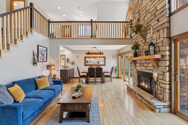 708 Riverside Dr N, North Hudson, WI 54016 - living area featuring wood-type flooring, a high ceiling, recessed lighting, stairs, and a chandelier