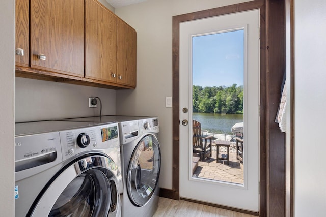 708 Riverside Dr N, North Hudson, WI 54016 - washroom with cabinet space, independent washer and dryer, light wood-style flooring, and a water view