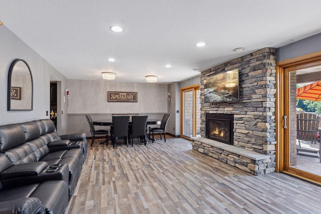 708 Riverside Dr N, North Hudson, WI 54016 - living area with wood finished floors, a stone fireplace, and recessed lighting