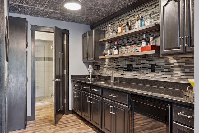 708 Riverside Dr N, North Hudson, WI 54016 - indoor dry bar with beverage cooler, light wood-style floors, an ornate ceiling, and tasteful backsplash