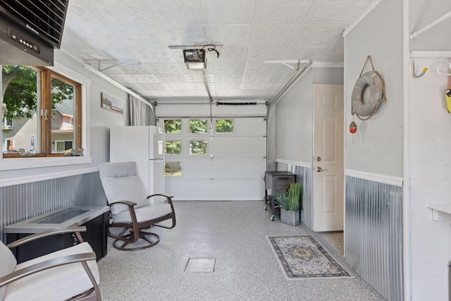 708 Riverside Dr N, North Hudson, WI 54016 - garage with freestanding refrigerator, an ornate ceiling, and a wainscoted wall