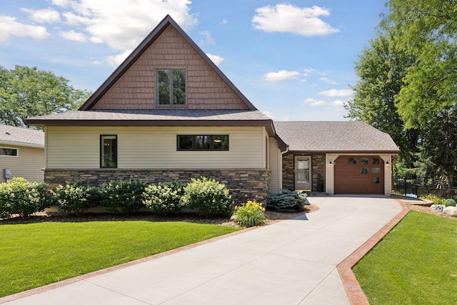 708 Riverside Dr N, North Hudson, WI 54016 - craftsman inspired home with a garage, driveway, stone siding, and a shingled roof