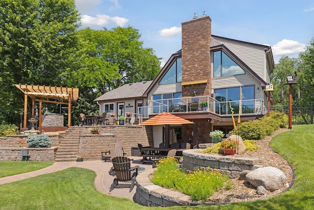 708 Riverside Dr N, North Hudson, WI 54016 - back of property featuring a patio area, a pergola, a chimney, a lawn, and a deck