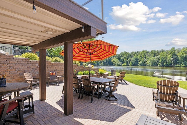 708 Riverside Dr N, North Hudson, WI 54016 - fenced backyard with a patio, outdoor dining area, and a water view