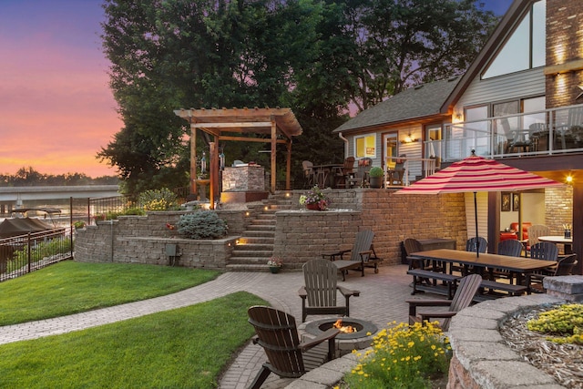 708 Riverside Dr N, North Hudson, WI 54016 - patio terrace at dusk featuring an outdoor fire pit, a balcony, a patio, stairway, and outdoor dining space