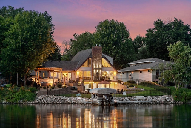 708 Riverside Dr N, North Hudson, WI 54016 - back of property featuring a chimney and a deck with water view
