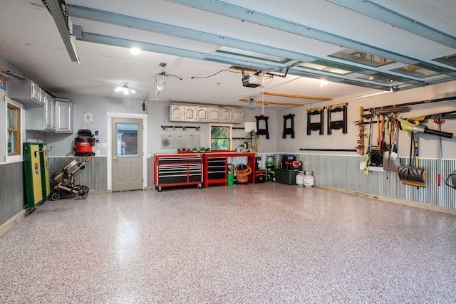 708 Riverside Dr N, North Hudson, WI 54016 - garage featuring a workshop area, wainscoting, and a garage door opener