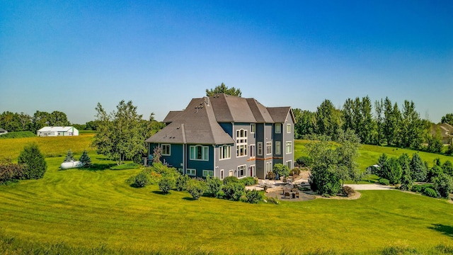 60515 235th St, Madison Lake, MN 56063 - view of side of home with a patio area and a yard