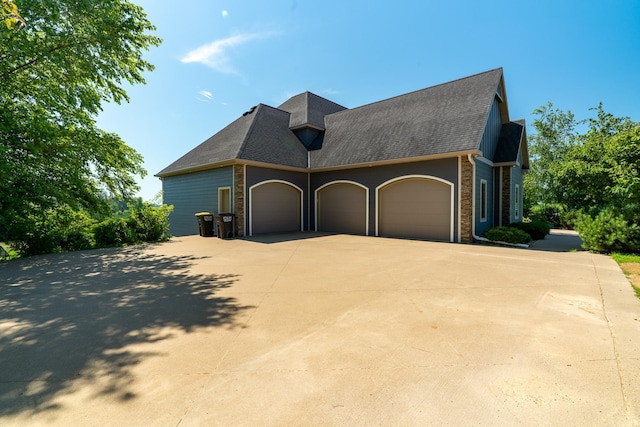 60515 235th St, Madison Lake, MN 56063 - view of side of property featuring an attached garage, driveway, and roof with shingles