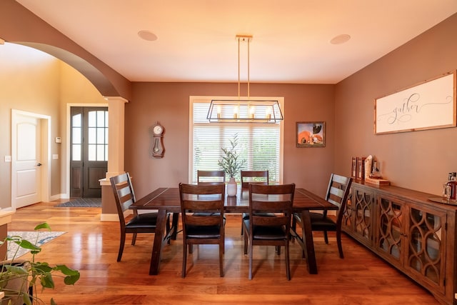60515 235th St, Madison Lake, MN 56063 - dining room with arched walkways, healthy amount of natural light, light wood finished floors, and decorative columns